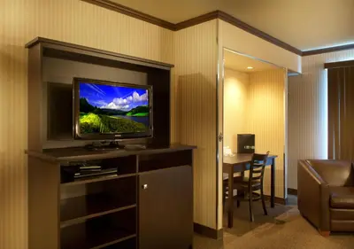 a hotel room with a flat screen tv in a room at Ramada by Wyndham Laval in Laval