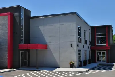 a black building with a red trim at Hôtel Ô Laval in Laval