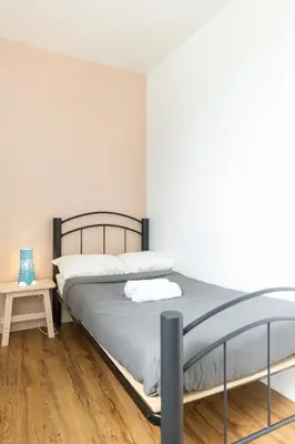 a bedroom with a bed and a wooden floor at Auberge Saintlo Montréal Hostel in Montréal
