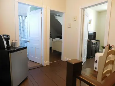 a room with a door open to a room with a kitchen at Au Coeur De Magog in Magog-Orford