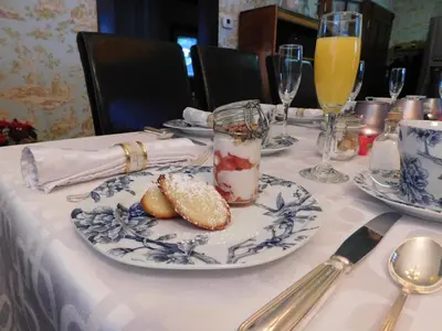 a table with plates of food and drinks on it at Au Coeur De Magog in Magog-Orford