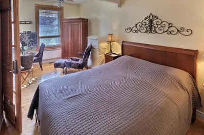 a bedroom with a bed and a table and chairs at Gite Le Sieur de Joliette in Montréal