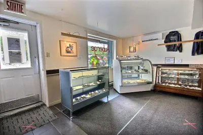 a store with an open refrigerator in a room at Auberge La Chocolatiere in North Hatley
