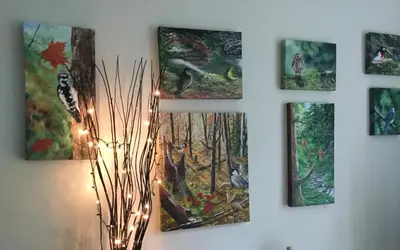 a group of paintings on a wall with lights at Au Gré Du Temps - Gîte B&B in Shefford