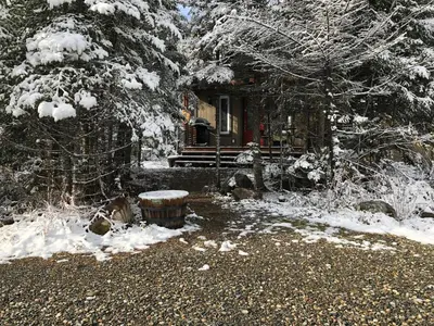 a cabin in the woods with snow covered trees at Chalet Milan in Milan