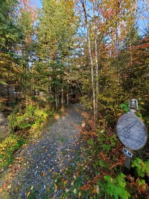 a path in the woods with a sign on it at Chalet Milan in Milan