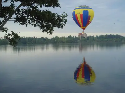 a hot air balloon flying over a body of water at Motel Belle Riviere in Saint-Jean-sur-Richelieu