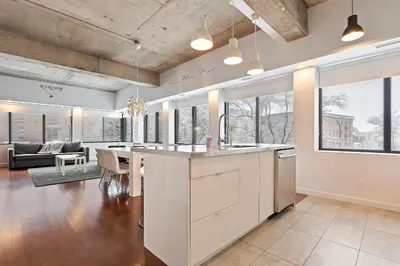 an open kitchen and living room with a dining room at mtlFlats - Condotel Le Luxe in Montréal
