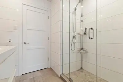 a bathroom with a shower and a glass door at mtlFlats - Condotel Le Luxe in Montréal