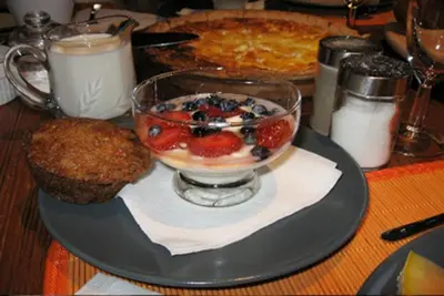 a table with a bowl of fruit and a pie at Gite L'Imprévu in Montréal
