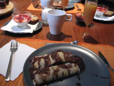 a table with a plate of food on a table at Gite L'Imprévu in Montréal