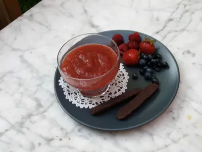 a plate with a bowl of jam and strawberries and blueberries at Gite L'Imprévu in Montréal