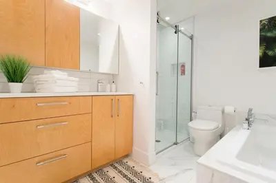 a bathroom with a toilet and a sink and a shower at Hip, Stylish Apartment in Little Italy by Den Stays A in Montréal