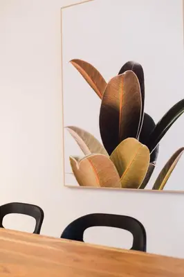 a table with chairs and a picture on the wall at Hip, Stylish Apartment in Little Italy by Den Stays A in Montréal