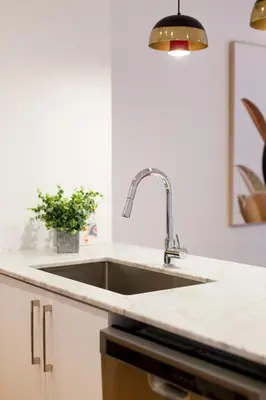 a kitchen with a sink and a counter top at Hip, Stylish Apartment in Little Italy by Den Stays A in Montréal