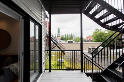 a balcony with a view of a building at Hip, Stylish Apartment in Little Italy by Den Stays A in Montréal