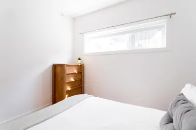 a bedroom with a bed and a window at Little Italy Spacious 2 Bedroom Condo Free Parking in Montréal