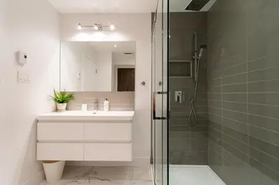 a bathroom with a sink and a shower at Little Italy Spacious 2 Bedroom Condo Free Parking in Montréal