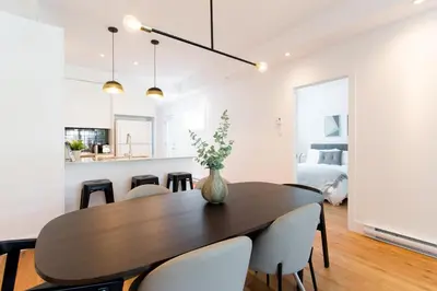 a dining room with a table and chairs at Little Italy Spacious 2 Bedroom Condo Free Parking in Montréal