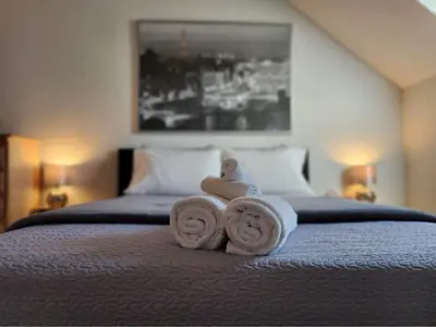 a pile of towels sitting on top of a bed at O'Berge du Village C304 - Bord de l'eau in Magog-Orford