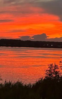 a sunset over a body of water at Motel Le Charentais in Sorel