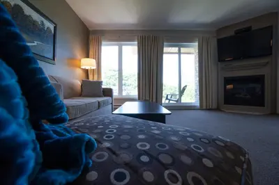 a living room with a couch and a fireplace at Condos Château-Bromont in Bromont