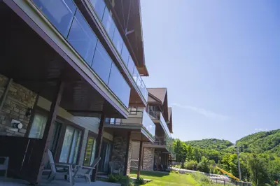 a house with glass windows on the side of it at Condos Château-Bromont in Bromont