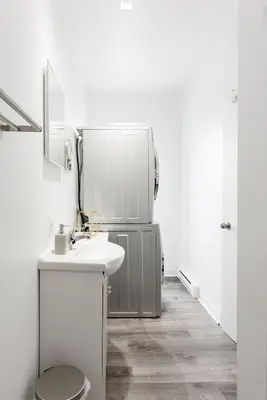 a bathroom with a sink and a refrigerator at Apartments Near Montreal Olympic Park in Montréal