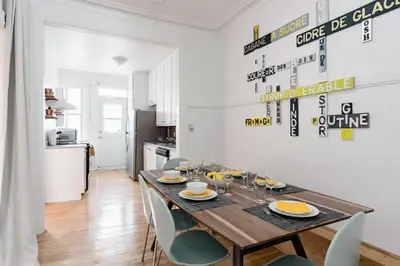 a dining room with a wooden table and chairs at Apartments Near Montreal Olympic Park in Montréal