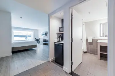 a room with a bed and a kitchen and a bathroom at Holiday Inn Express Hotel & Suites Saint - Hyacinthe by IHG in Saint-Hyacinthe