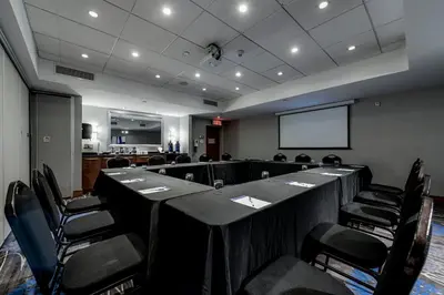 a conference room with a long table and chairs at Holiday Inn Express Hotel & Suites Saint - Hyacinthe by IHG in Saint-Hyacinthe
