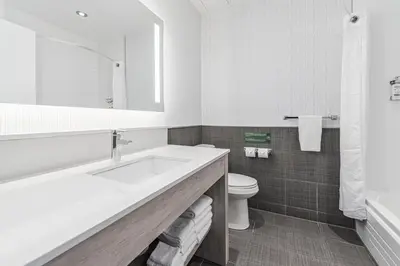 a white bathroom with a sink and a toilet at Holiday Inn Express Hotel & Suites Saint - Hyacinthe by IHG in Saint-Hyacinthe