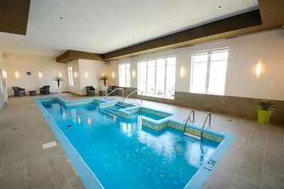 a pool in a hotel with two swimming pools at Imperia Hôtel et Suites Terrebonne in Terrebonne