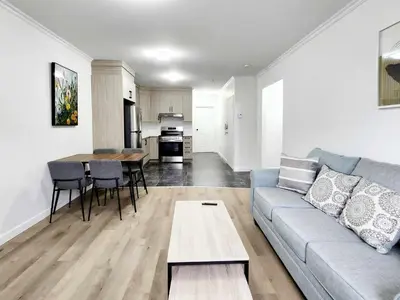 a living room with a couch and a table at APARTMENT HOTEL ST-DENIS in Montréal