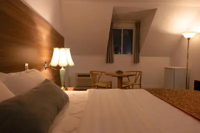 a hotel room with a bed and a table at Hotel Cowansville in Cowansville