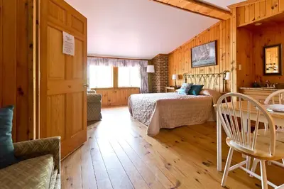 a bedroom with a bed and a table in a room at Auberge Papillon Lune in Richmond