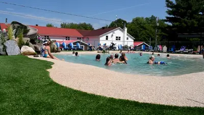 a group of people swimming in a swimming pool at Auberge Papillon Lune in Richmond