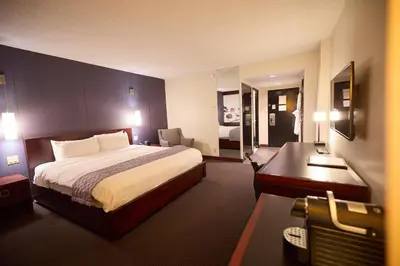 a hotel room with a bed and a desk at Hotel Ruby Foo's in Montréal