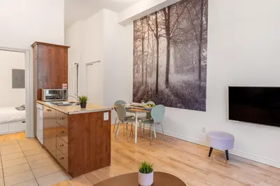 a kitchen with a table and chairs in a room at Alywin Apartments in Hochelaga in Montréal