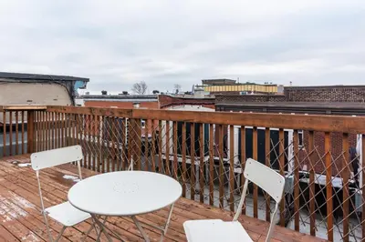 two white chairs and a table on a balcony at Alywin Apartments in Hochelaga in Montréal
