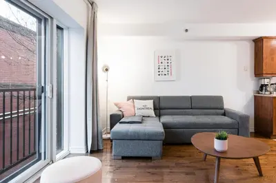 a living room with a couch and a table at Alywin Apartments in Hochelaga in Montréal