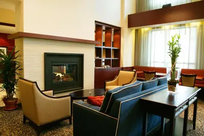 a lobby with couches and a fireplace in a hotel at Hampton Inn & Suites Laval in Laval