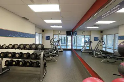 a fitness room with treadmills and weights at Hampton Inn & Suites Laval in Laval