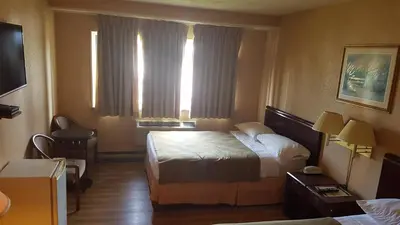 a hotel room with a bed and a window at Chomedey Inn in Laval