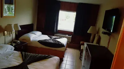 a hotel room with two beds and a window at Chomedey Inn in Laval