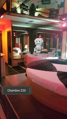 a room with two beds and a machine in it at Chomedey Inn in Laval