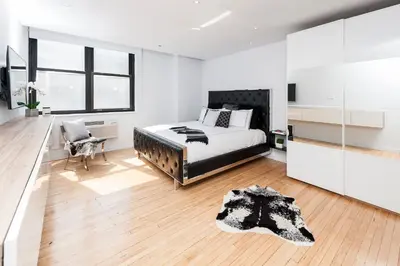 a bedroom with a bed and a desk and a chair at The Holland Hotel by Simplissimmo in Montréal