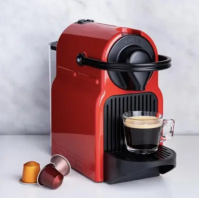 a red coffee maker with a cup of coffee at The Holland Hotel by Simplissimmo in Montréal
