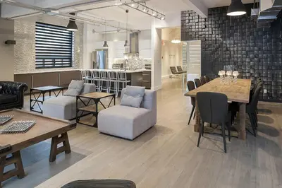 a restaurant with tables and chairs and a kitchen at The Holland Hotel by Simplissimmo in Montréal