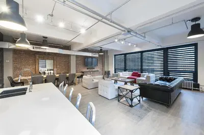 a living room with couches and tables and chairs at The Holland Hotel by Simplissimmo in Montréal